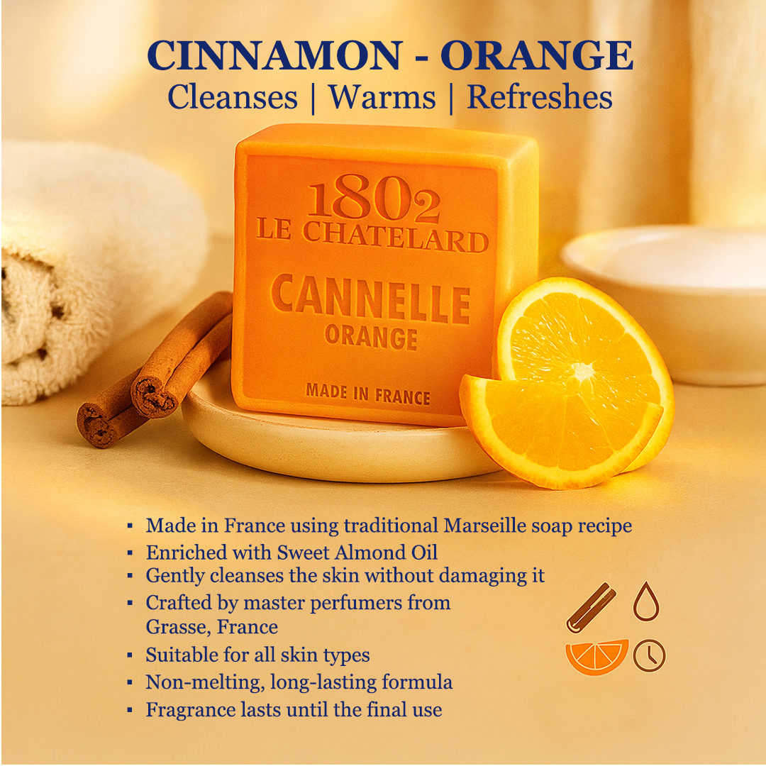 Orange soap bar with cinnamon sticks and lemon slices on a beige background