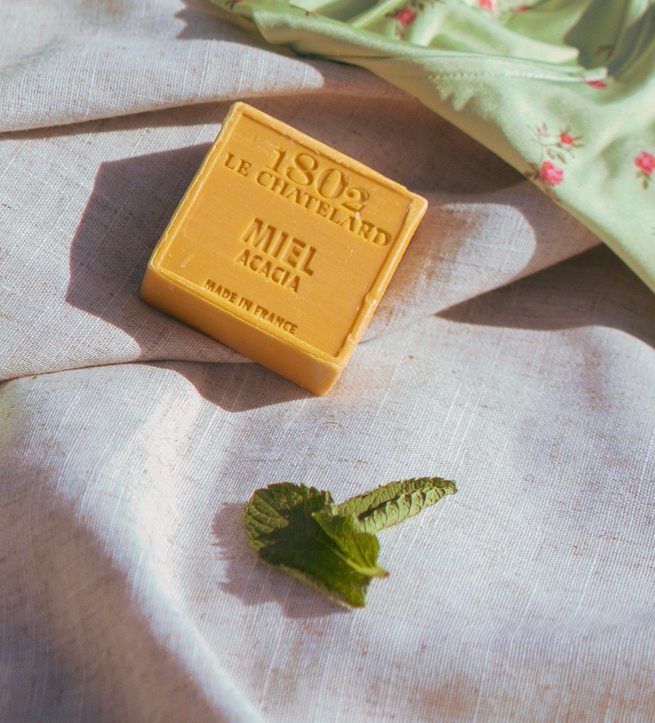 Bar of soap with 'Le Chatelard 1802' branding on a textured fabric background