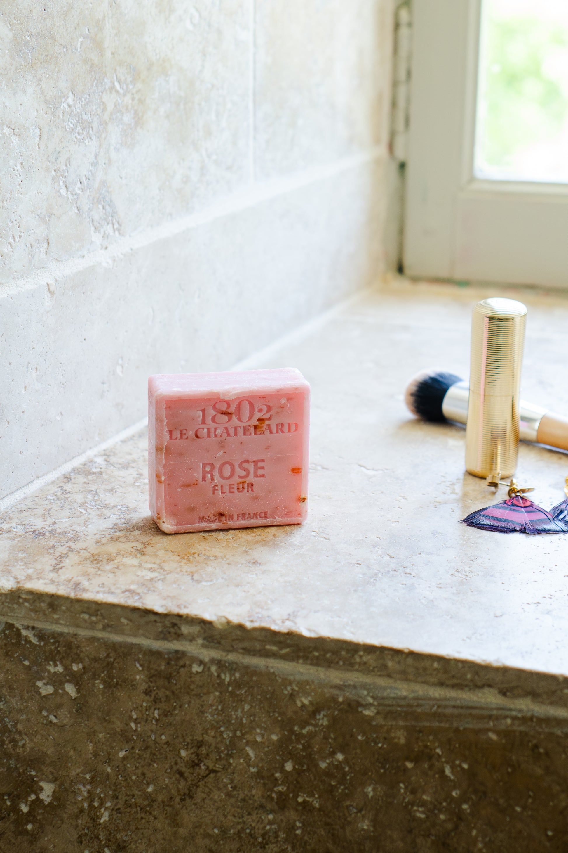 Bar of soap on a bathroom counter with a window in the background