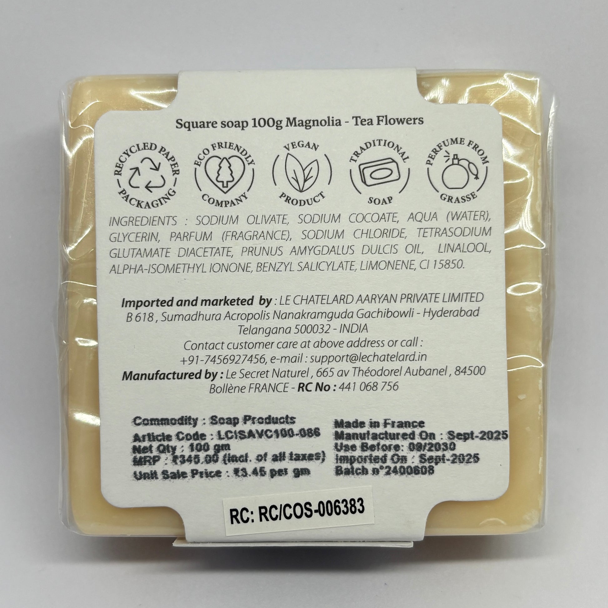 Packaged soap bar with a label on a gray background