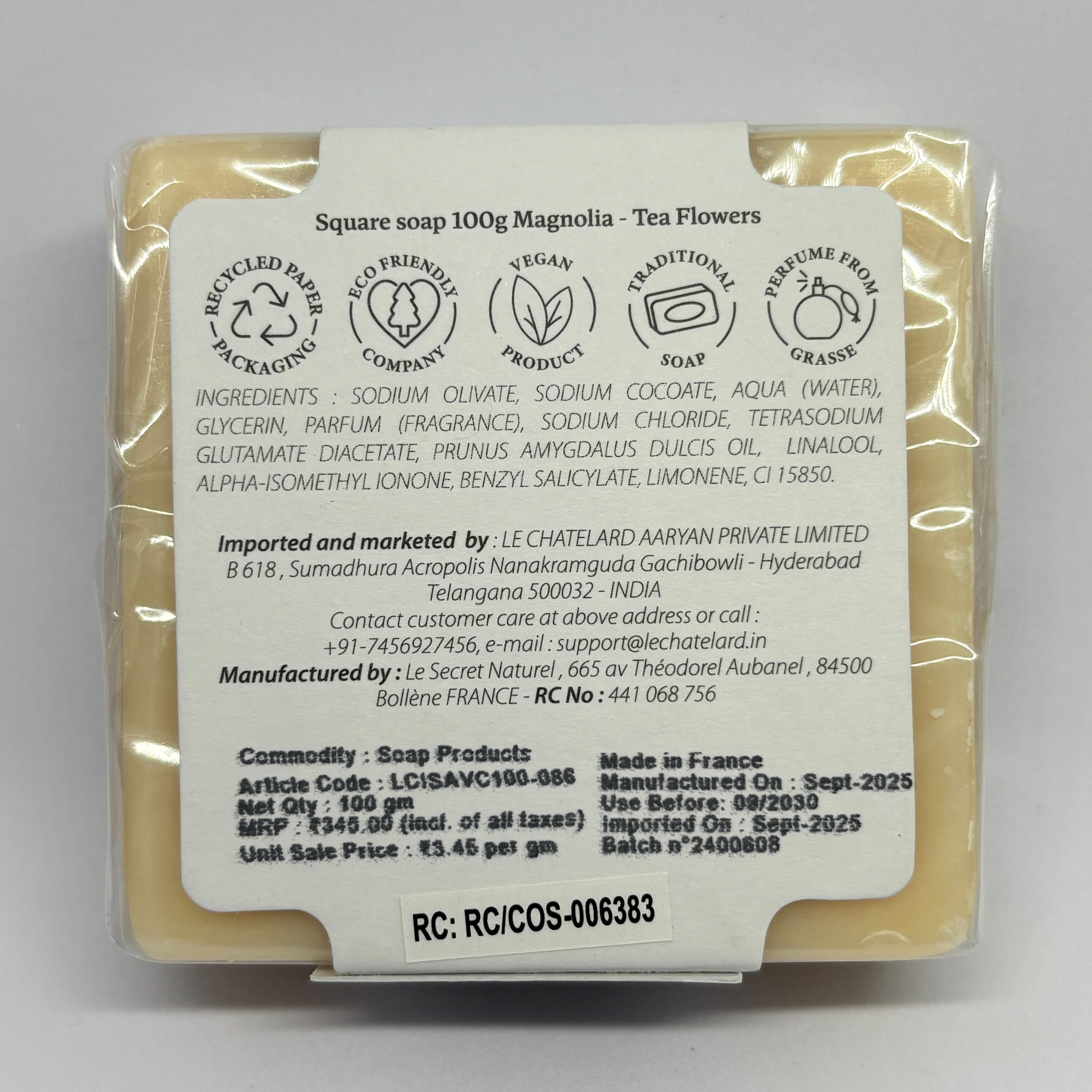 Packaged soap bar with a label on a gray background