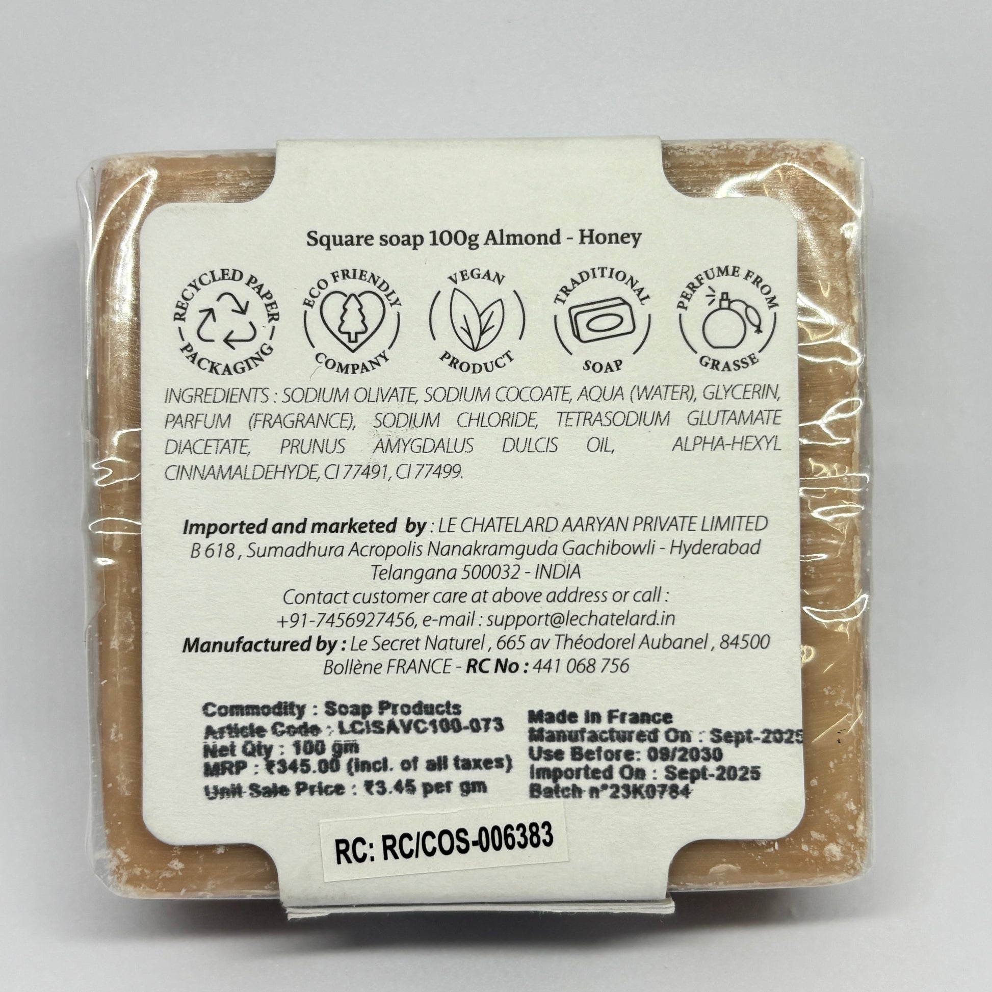 Back view of a soap bar with packaging details on a gray background