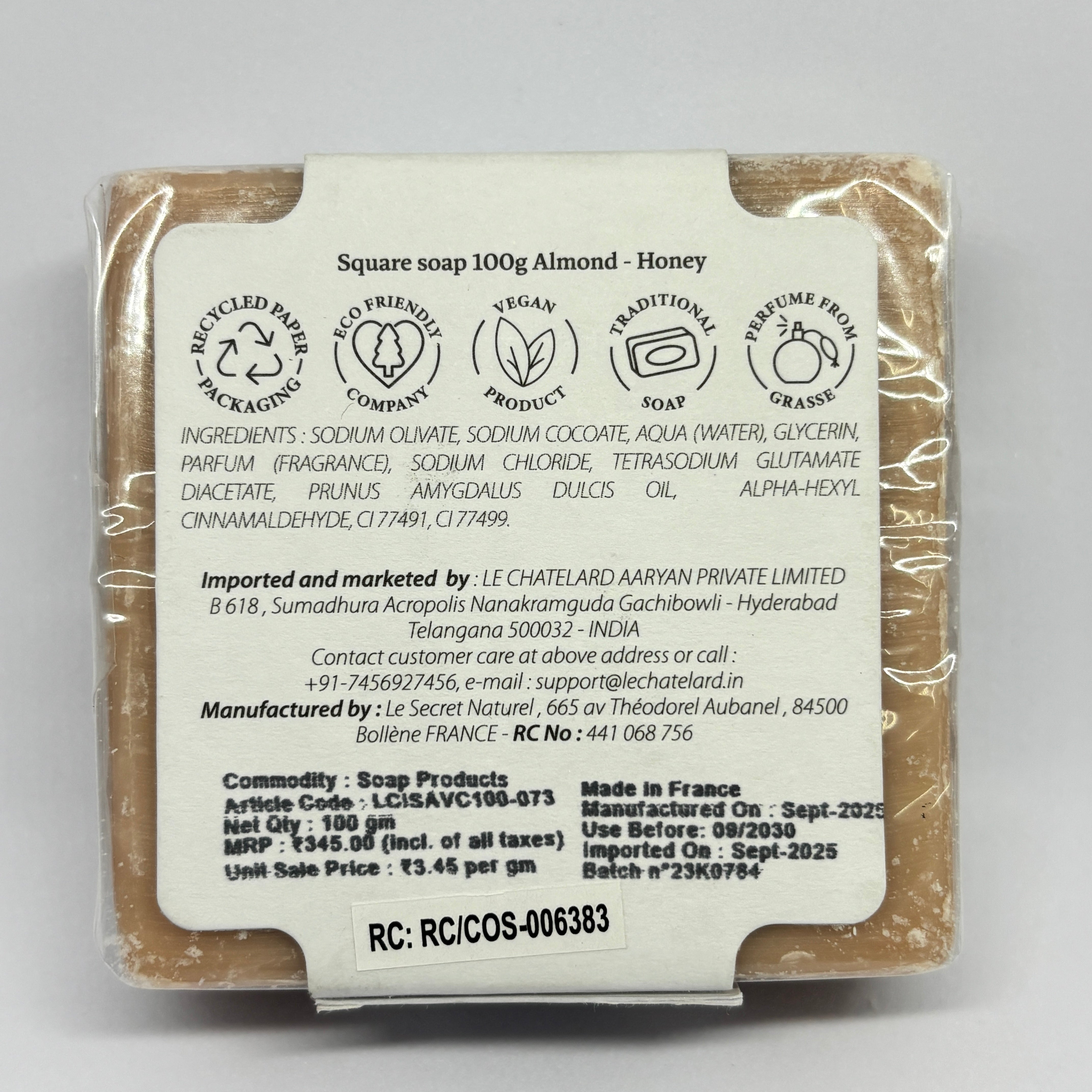 Back view of a soap bar with packaging details on a gray background