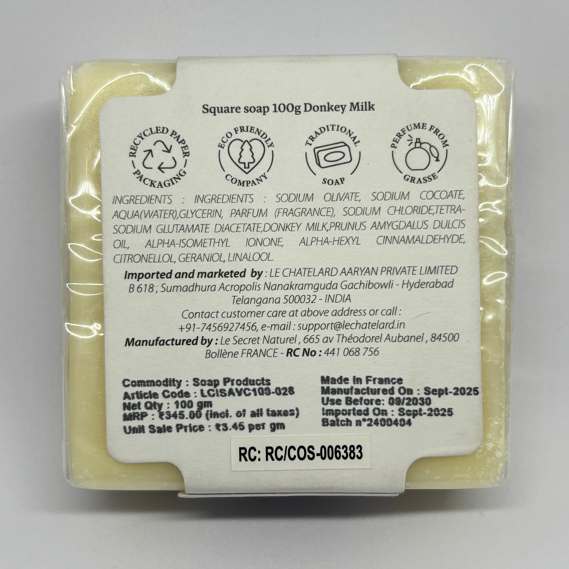 Donkey milk soap bar with packaging label on a gray background