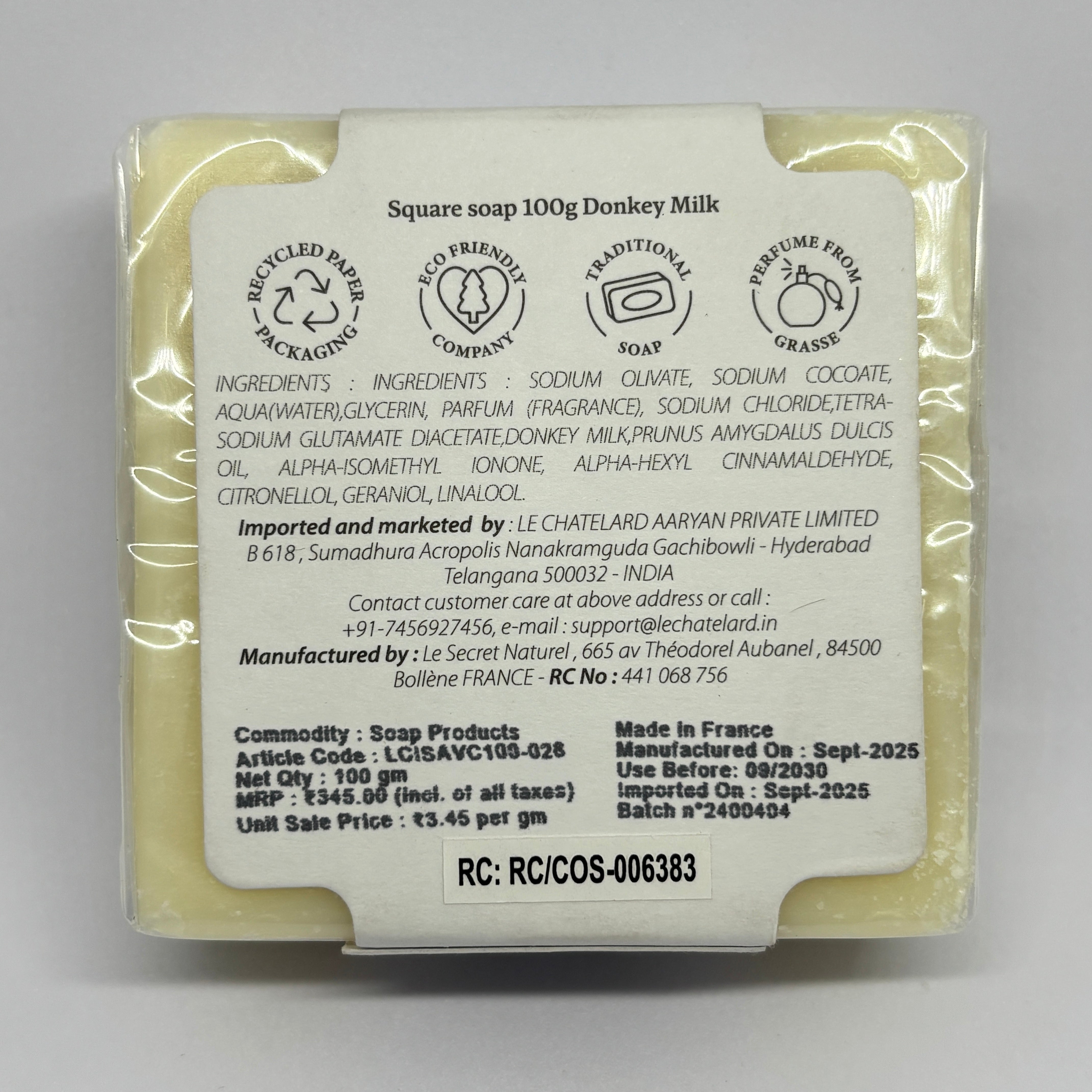 Donkey milk soap bar with packaging label on a gray background