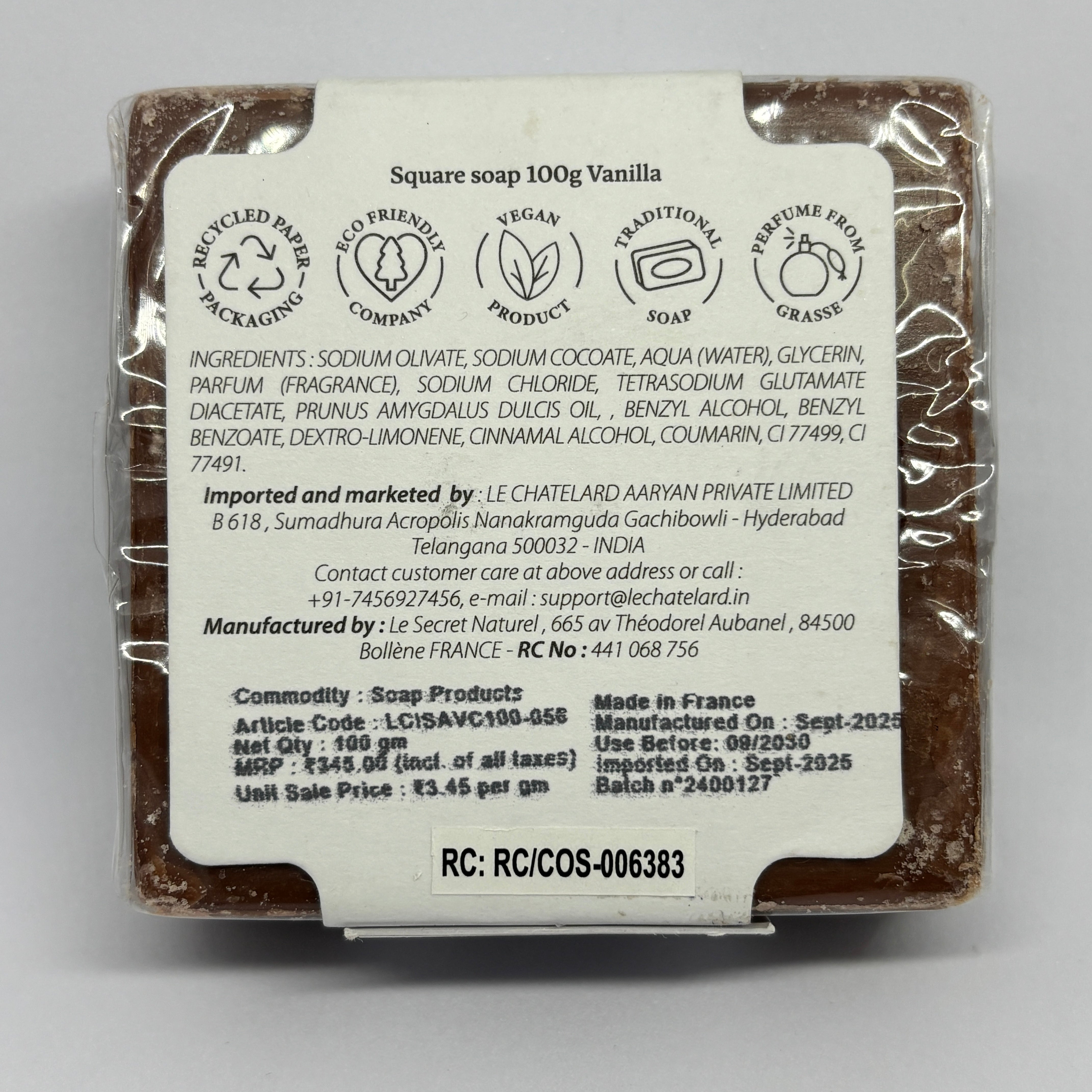 Vanilla soap bar with packaging and label on a gray background