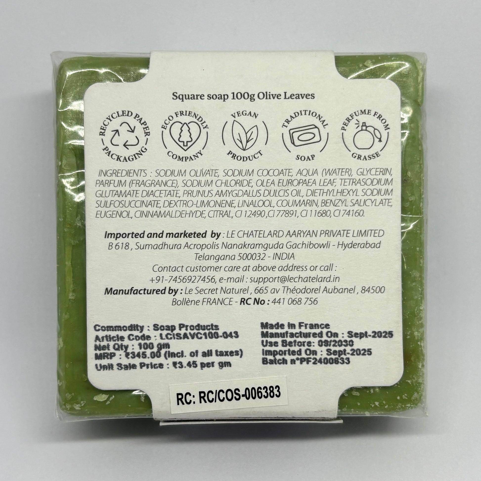 Back view of a soap packaging with text and branding details on a gray background