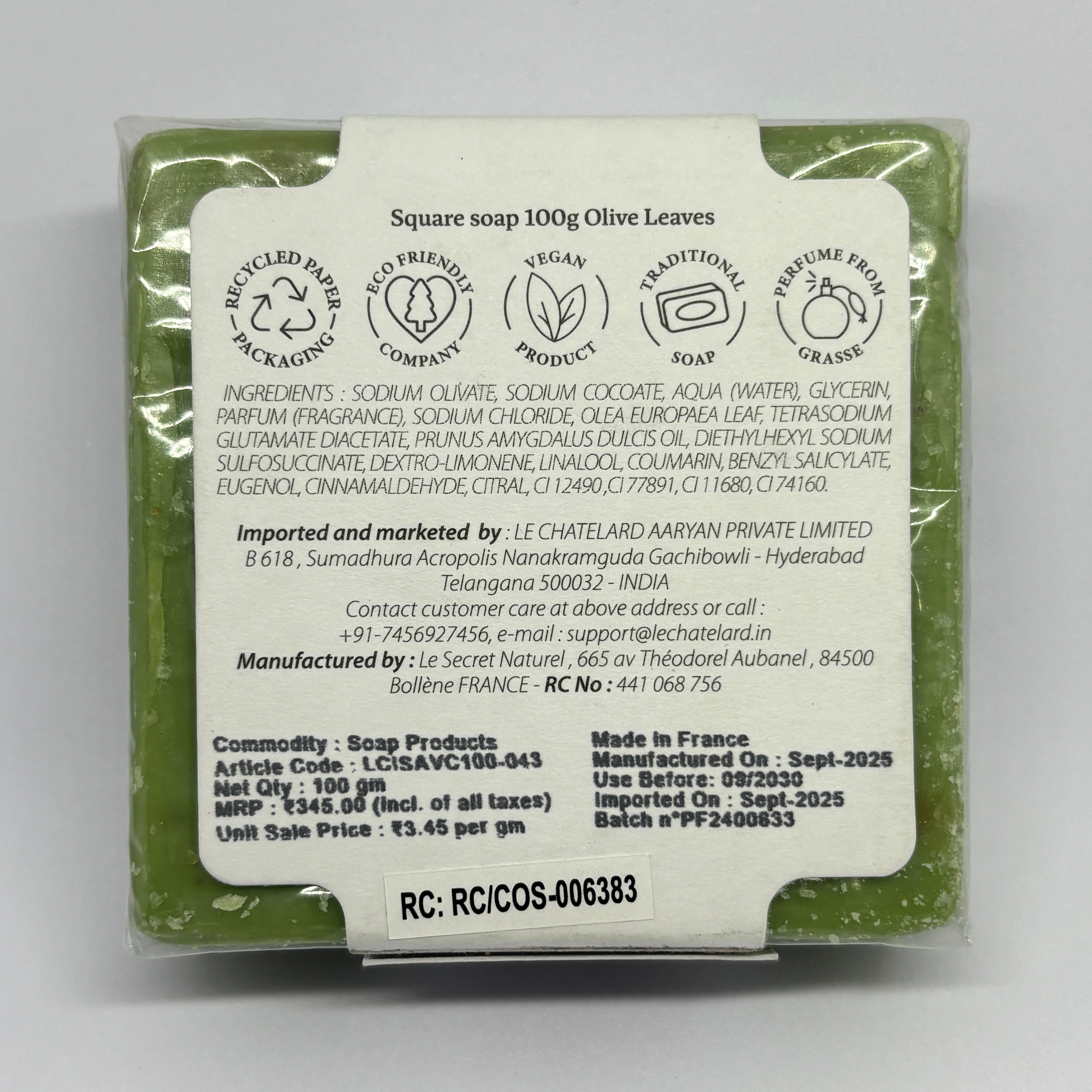 Back view of a soap packaging with text and branding details on a gray background