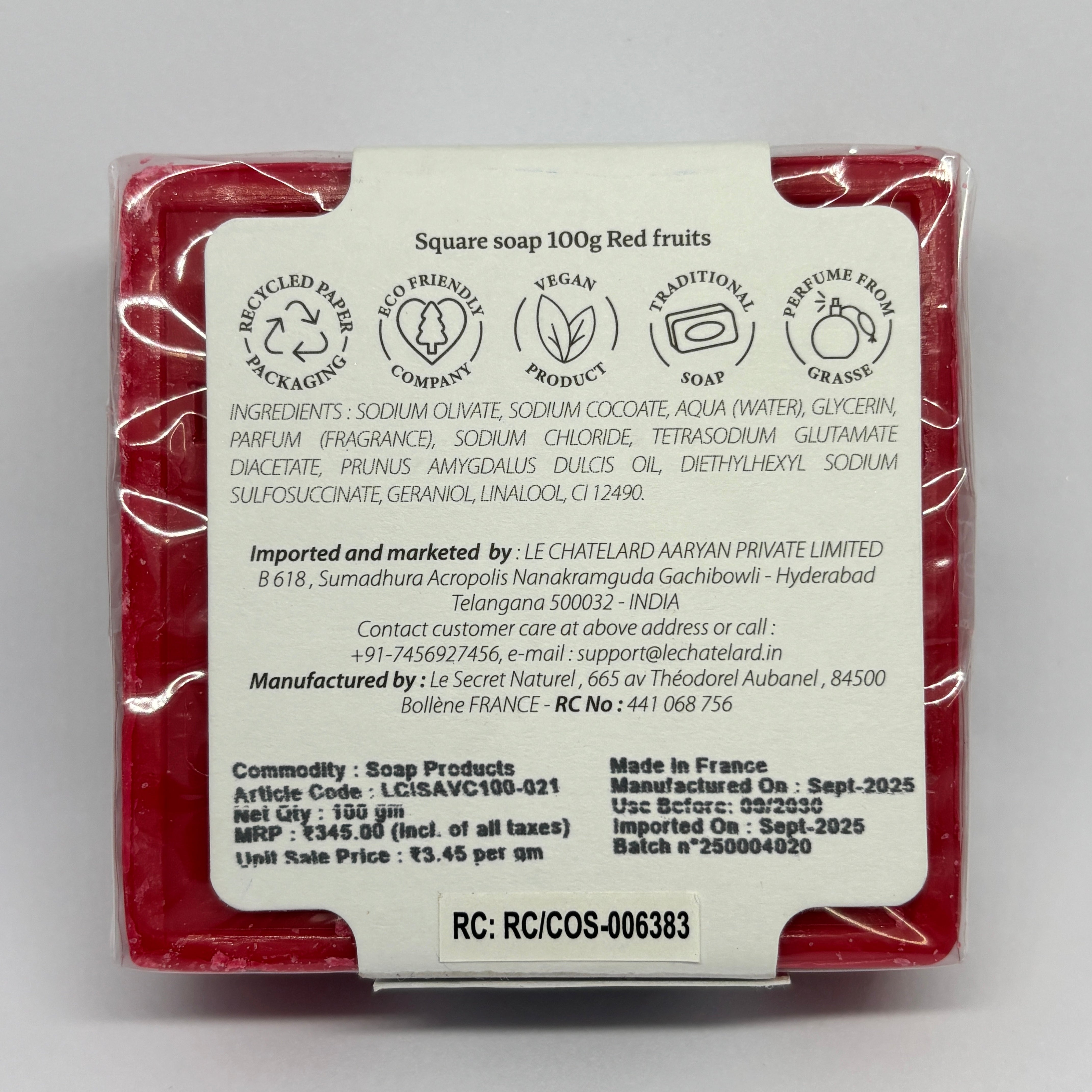 Back view of a red soap bar with packaging details on a gray background