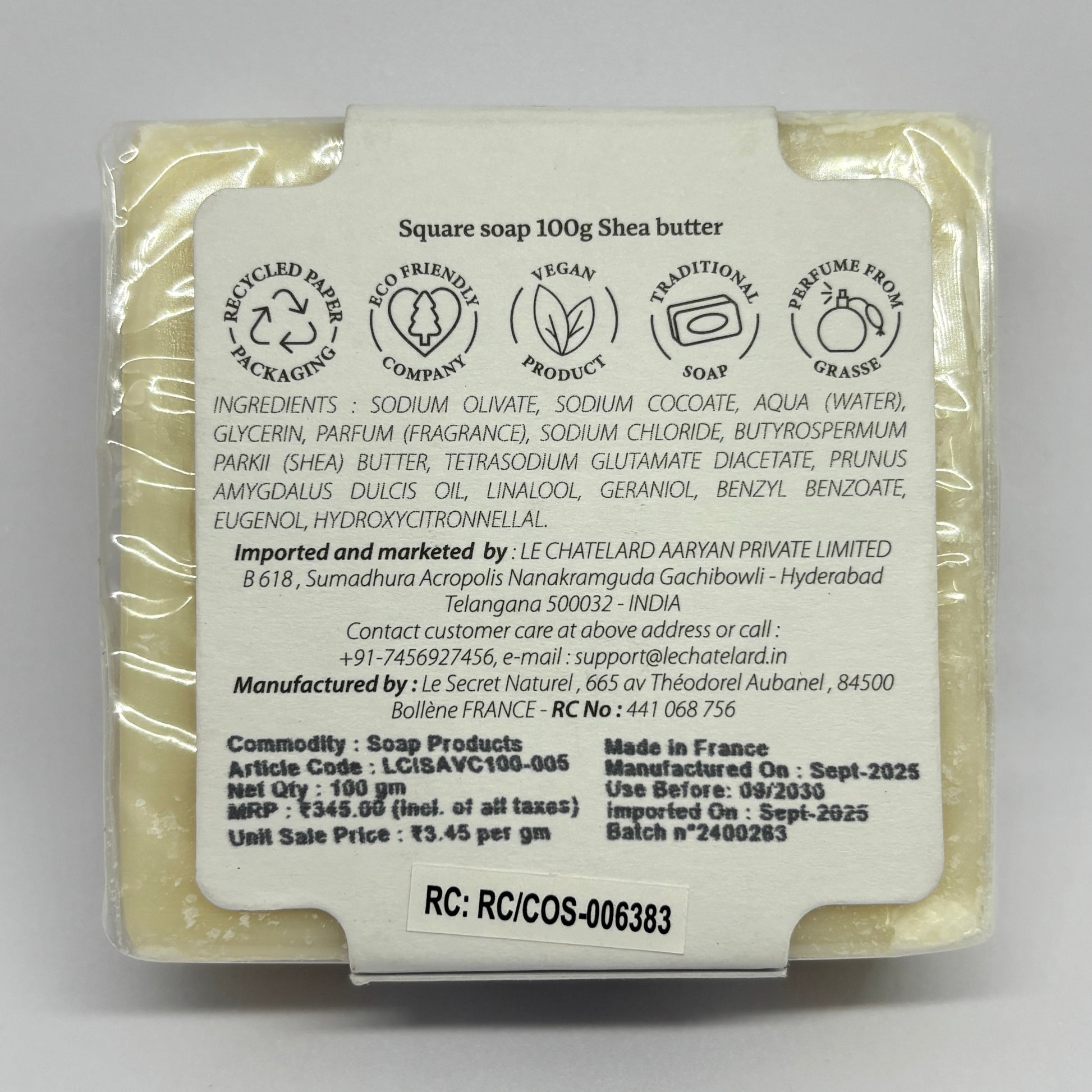 Shea butter soap bar with a label on a gray background