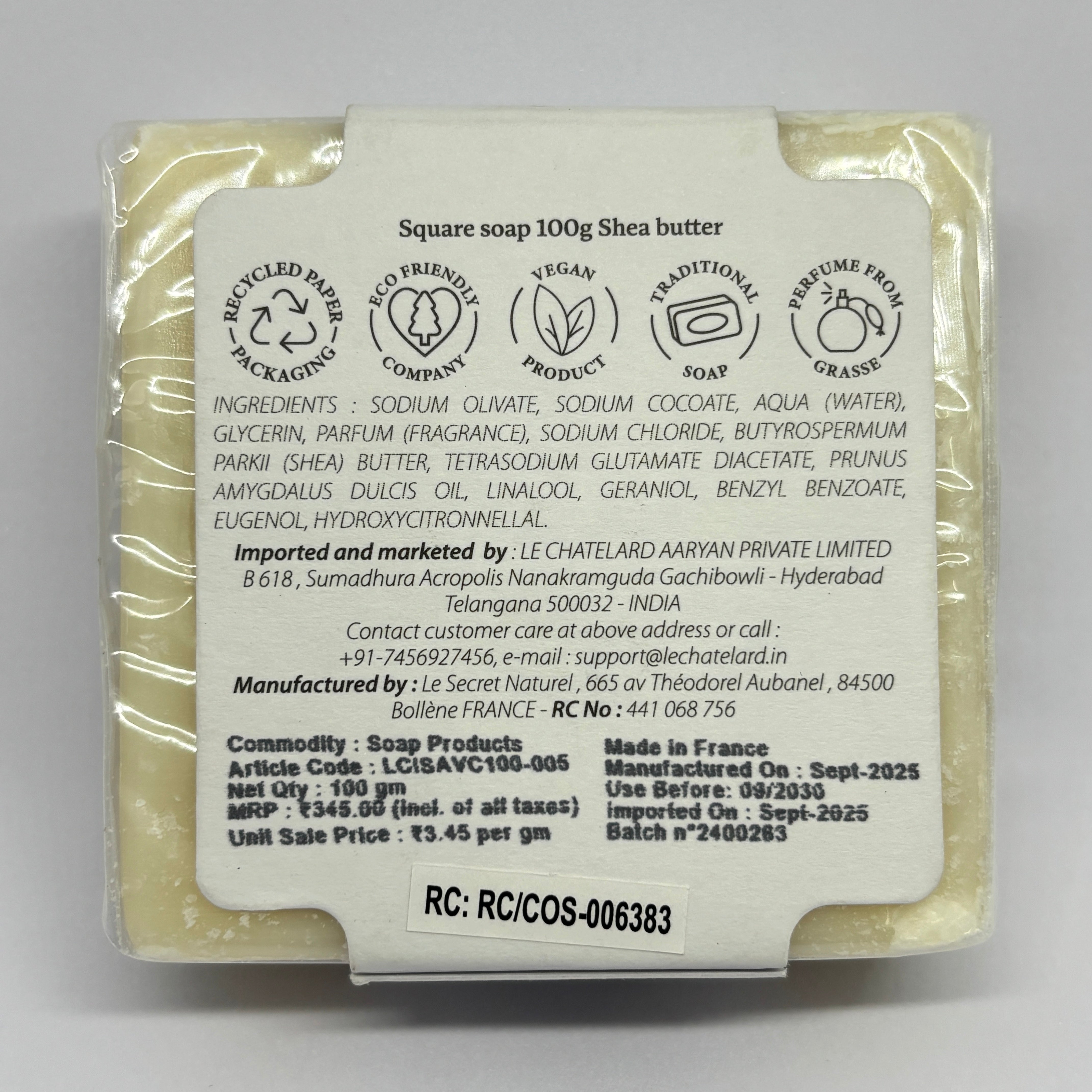 Shea butter soap bar with a label on a gray background