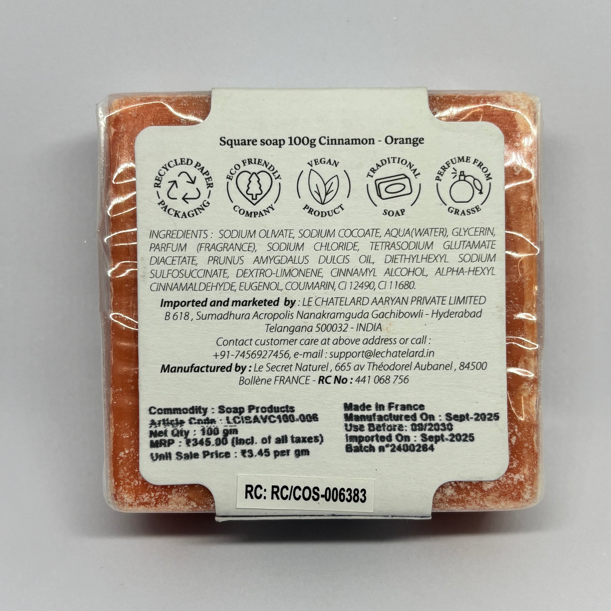 Square soap bar with packaging label on a gray background