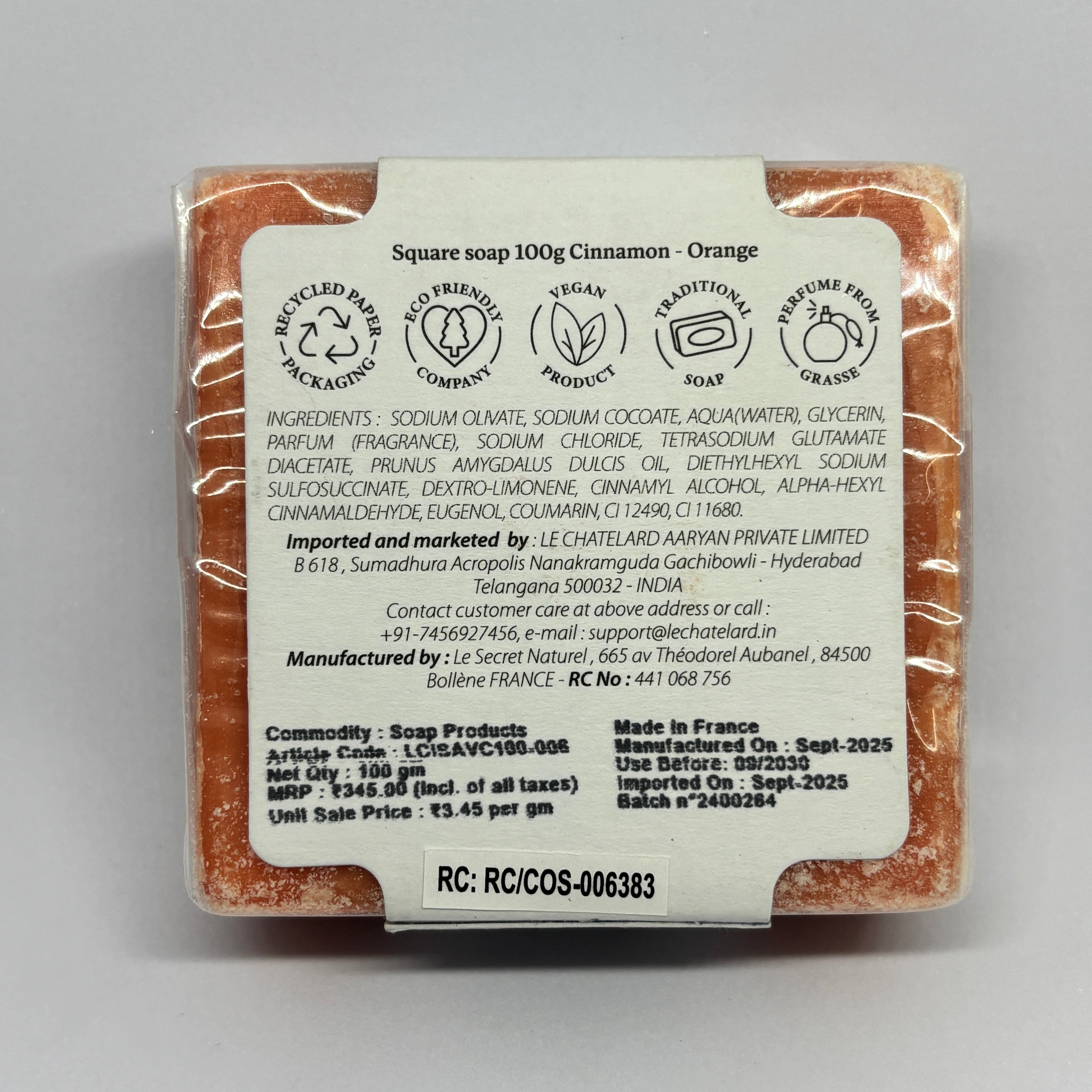 Square soap bar with packaging label on a gray background