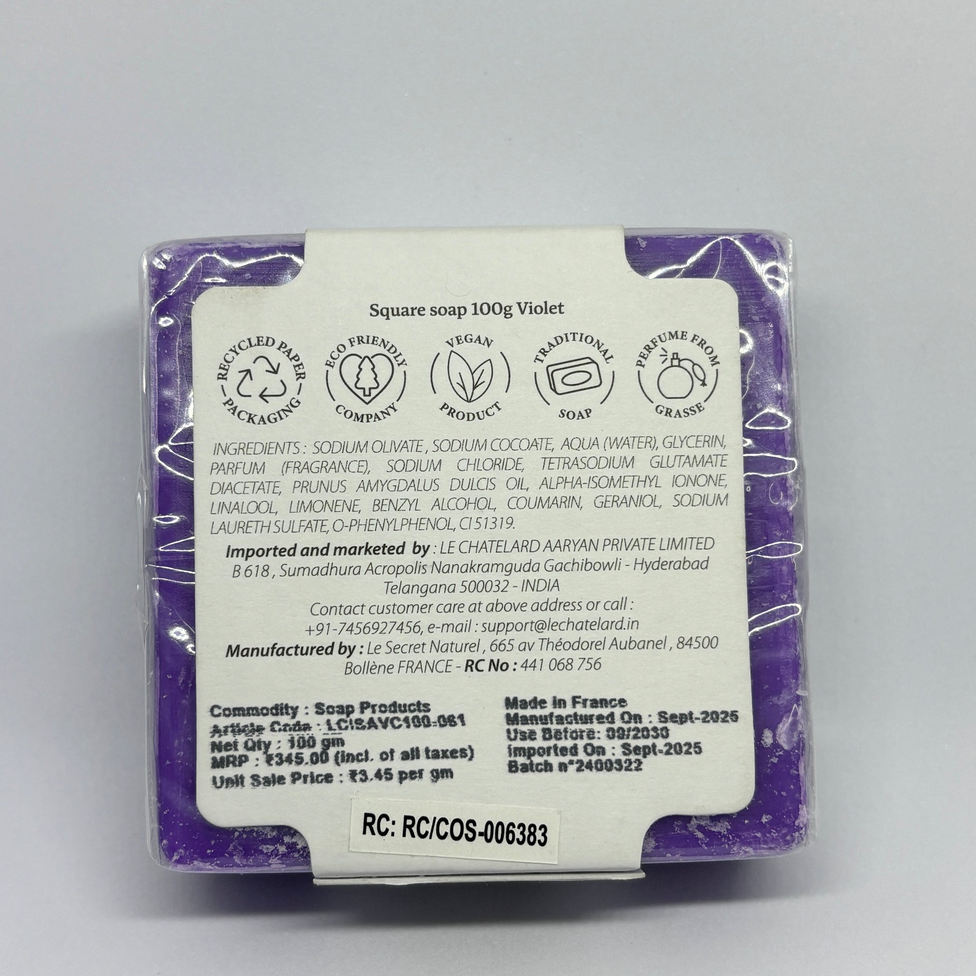 Purple soap bar with a label on a gray background