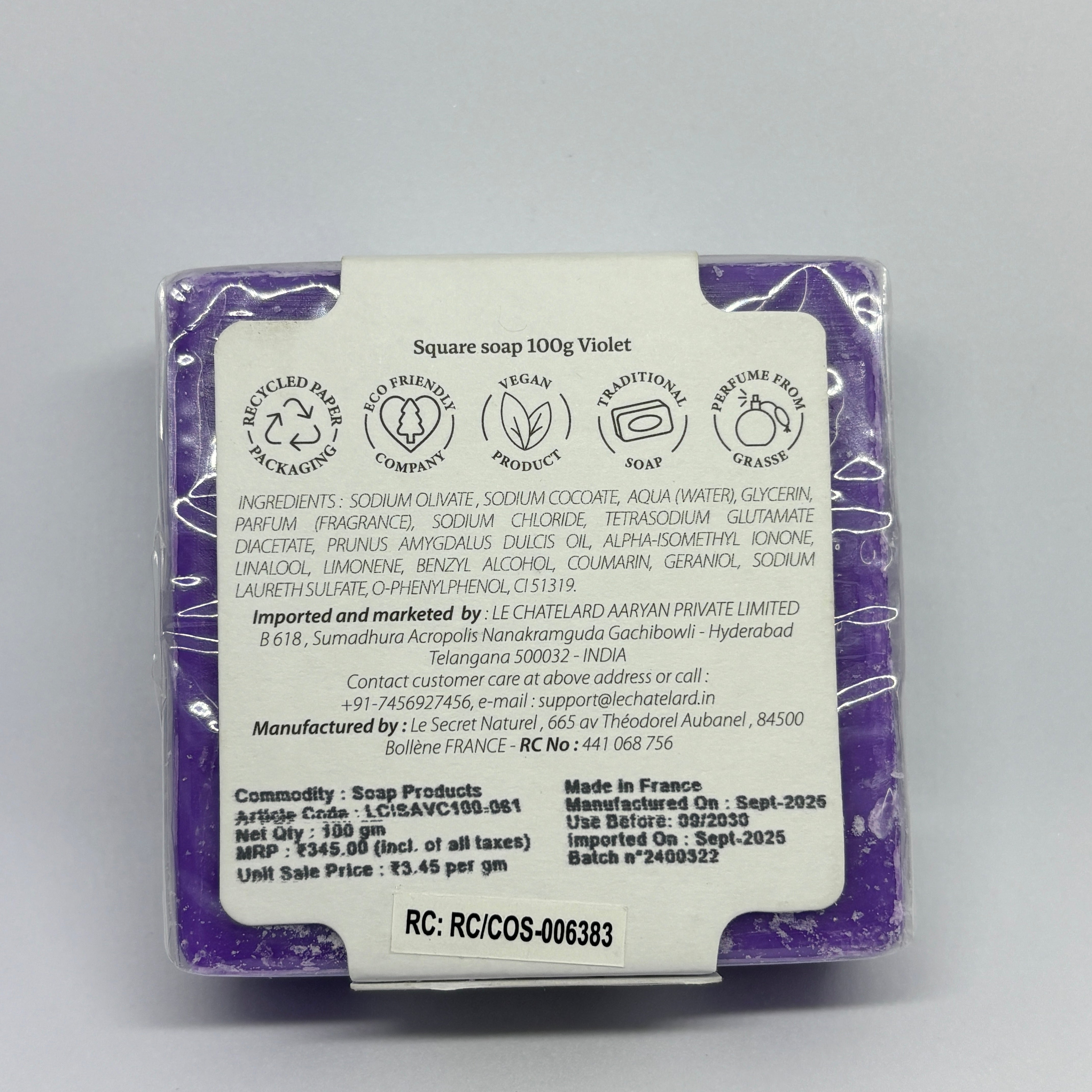 Purple soap bar with a label on a gray background
